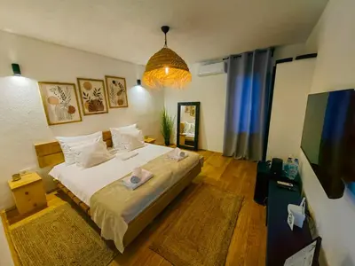 a bedroom with a large bed and a tv at Garden Relax Bungalow 