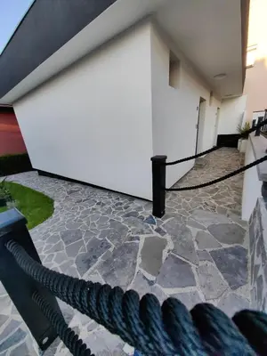 a large white wall with a black rope at Garden Relax Bungalow 
