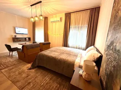 a hotel room with a bed and a desk at AD BASANTE in Bosanski Šamac
