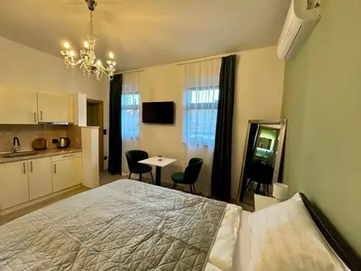 a bedroom with a bed and a table and chairs at AD BASANTE in Bosanski Šamac