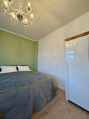 a bedroom with a bed and a chandelier at AD BASANTE in Bosanski Šamac