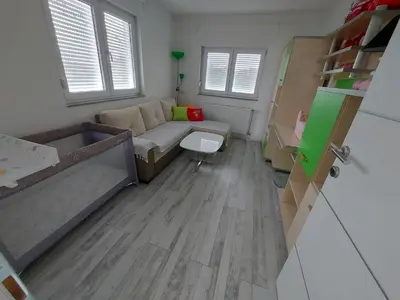 a small room with a couch and a table at Apartman TT Stan na dan Trn Laktaši in Laktaši