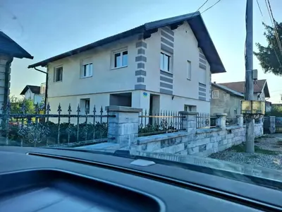 a house seen through a car window at Apartman TT Stan na dan Trn Laktaši in Laktaši