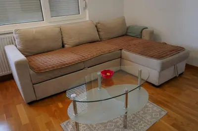 a living room with a couch and a glass table at Apartman KoprenaZ in Banja Luka