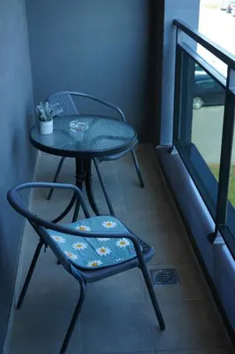 a table and a chair sitting next to a window at Apartman KoprenaZ in Banja Luka