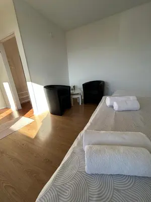 a bedroom with two beds with white towels on them at Rooms ALEA in Sanski most
