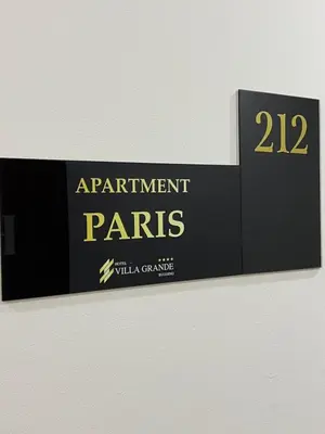 a sign for the entrance to the entrance to apartment parks at Apartmani Villa Grande in Bugojno