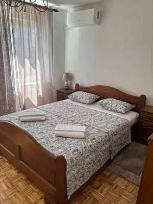 a bedroom with a bed with two towels on it at APARTMAN ADI in Jajce