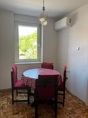 a room with a table and chairs and a window at APARTMAN ADI in Jajce