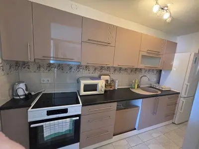 a kitchen with white cabinets and a microwave at APARTMAN ADI in Jajce
