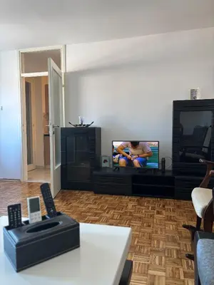 a living room with a tv and a table at APARTMAN ADI in Jajce