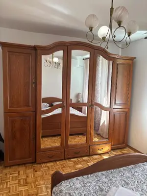 a large wooden cabinet in a room with a bed at APARTMAN ADI in Jajce