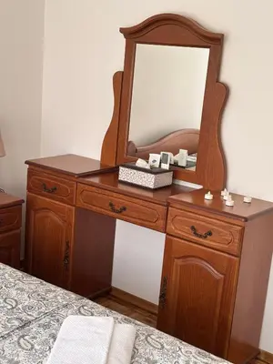 a wooden dresser with a mirror on top of it at APARTMAN ADI in Jajce