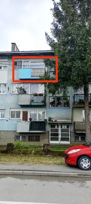 a red car parked in front of a building at Stan na dan Kej Una in Bosanska Dubica