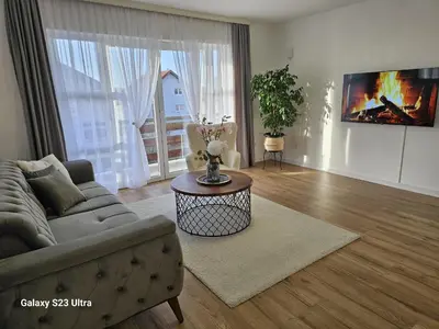 a living room with a couch and a table at Apartment City View in Bihać