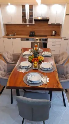 a kitchen with a wooden table with food on it at Apartment City View in Bihać