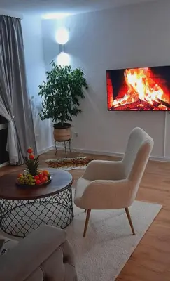 a living room with a fire painting on the wall at Apartment City View in Bihać