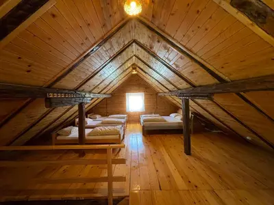 a room with four bunk beds in a wooden attic at 