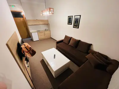 a living room with a couch and a table at Stan na dan / rent-a-flat per day in Bugojno