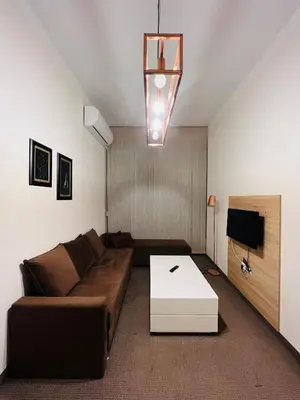 a living room with a couch and a table at Stan na dan / rent-a-flat per day in Bugojno