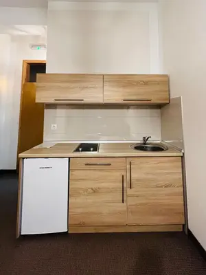 a kitchen with a sink and a white dishwasher at Stan na dan / rent-a-flat per day in Bugojno