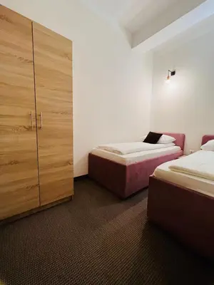 a room with two beds and a closet with two beds at Stan na dan / rent-a-flat per day in Bugojno