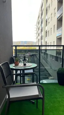 a patio with a table and chairs on a balcony at Stan 23 in Banja Luka