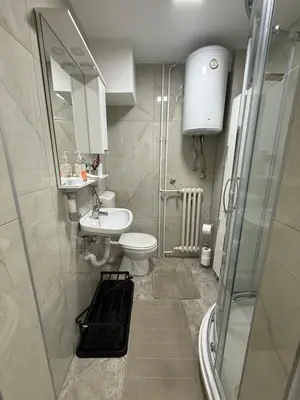a bathroom with a toilet and a sink and a shower at Luxapartman in Banja Luka