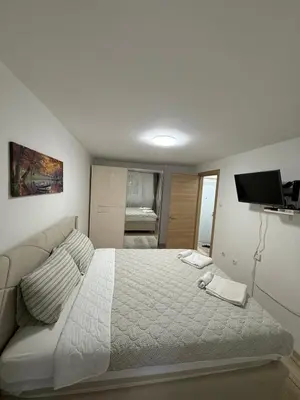 a bedroom with a large bed and a television at Luxapartman in Banja Luka