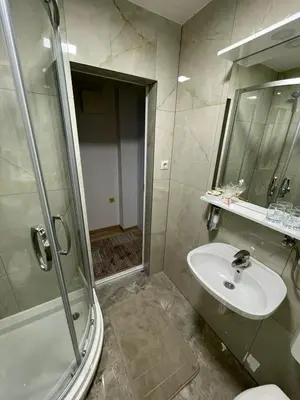 a bathroom with a sink and a shower at Luxapartman in Banja Luka
