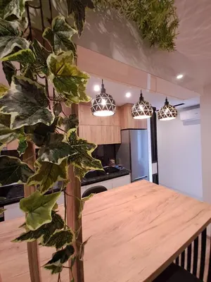 a kitchen with a wooden table and some plants at Stojanović Diwine in Banja Luka
