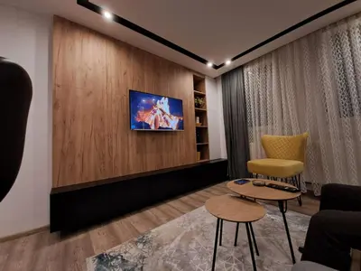 a waiting room with two chairs and a tv on a wall at Stojanović Diwine in Banja Luka