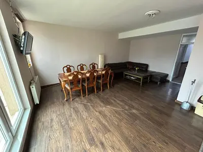 a living room with a table and chairs and a couch at Hotel Avanti in Zenica
