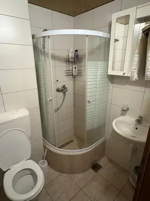 a bathroom with a shower and a toilet and a sink at Hotel Avanti in Zenica