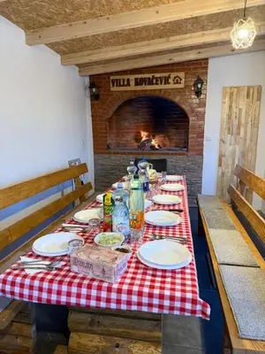 a table with a red and white checkered table cloth at Kuća za odmor Villa Kovačević in Bihać