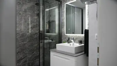 a bathroom with a white sink and a mirror at Apartman PLATINUM in Doboj
