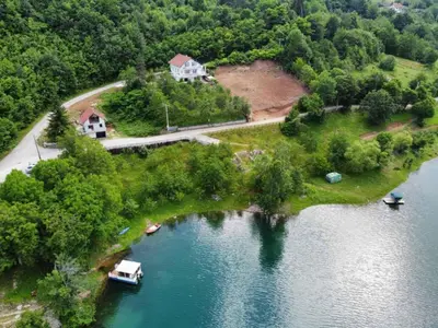 an aerial view of a house on an island in a lake at Apartman Manov - Ramsko jezero in Prozor