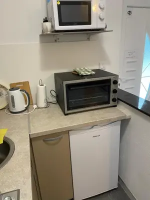 a microwave oven sitting on top of a kitchen counter at Apartman Manov - Ramsko jezero in Prozor