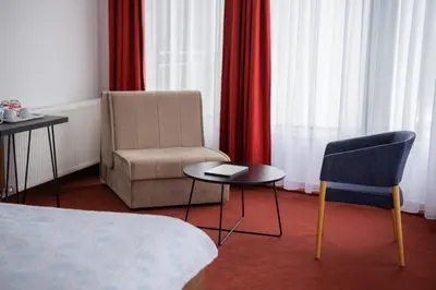 a room with a chair and a chair and a table at Soba Kašmir in Bugojno