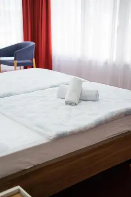 a bed with two white pillows on top of it at Soba Kašmir in Bugojno
