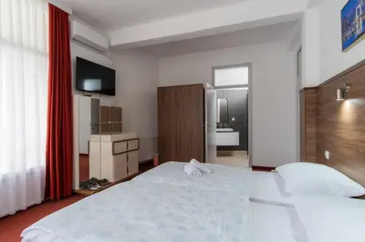 a hotel room with a bed and a bathroom at Soba Kašmir in Bugojno