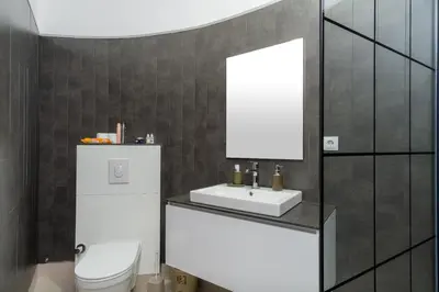 a bathroom with a white toilet and a sink at Soba Kašmir in Bugojno