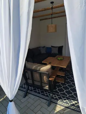 a living room with a table and a couch at Happy Vecation in Tuzla