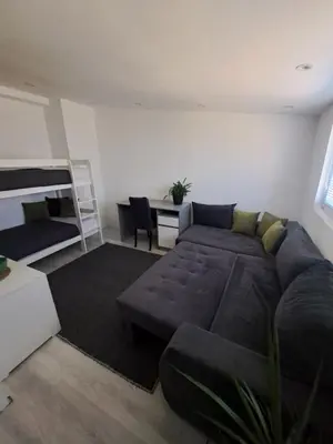 a living room with a couch and a bed at Happy Vecation in Tuzla