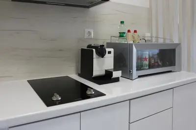 a kitchen counter with a coffee maker on it at West Wing - Apartmani Živinice in Živinice