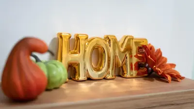 a wooden table with the word home written in gold at West Wing - Apartmani Živinice in Živinice