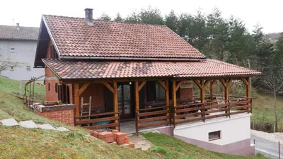 a house with a large roof on a hill at Kuća za Odmor Naša Priča in Šipovo