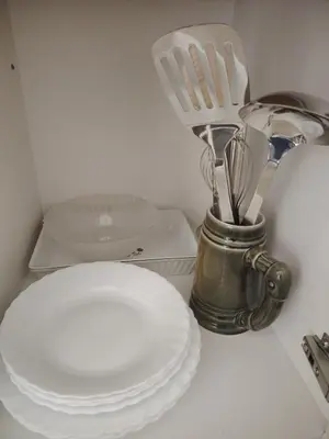 a counter top with plates and utensils and a blender at Stan na dan Prnjavor in Prnjavor