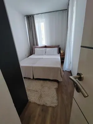a bed in a small room with a window at Stan na dan Prnjavor in Prnjavor