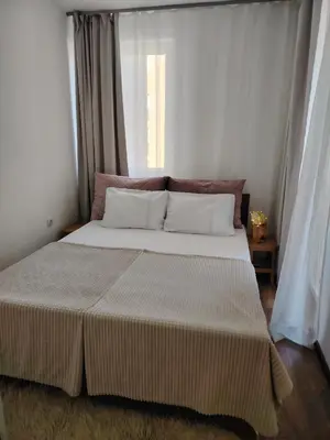 a bedroom with a large bed with a window at Stan na dan Prnjavor in Prnjavor